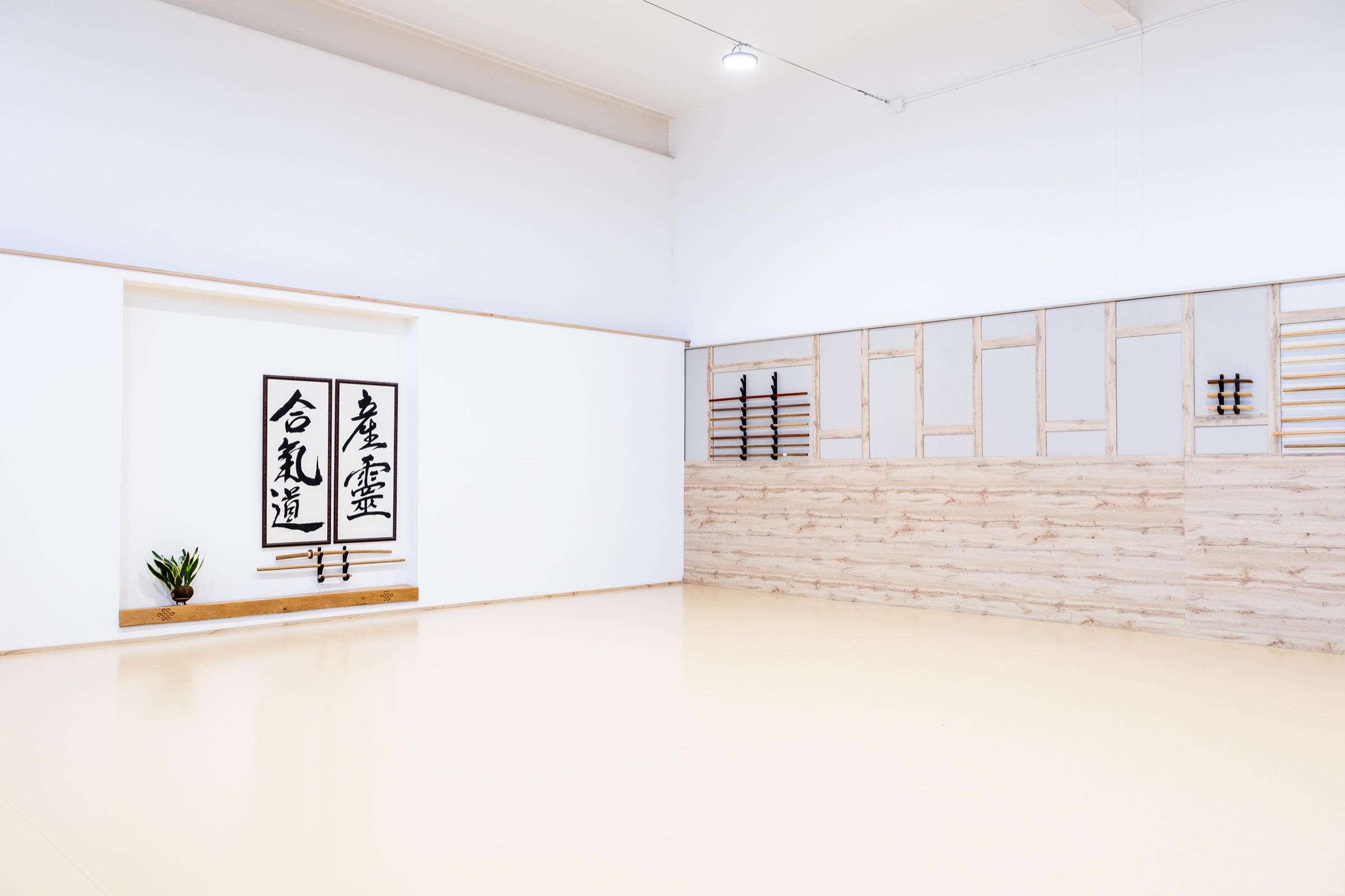 The dojo's kamiza, with the calligraphy for aikido and Musubi.