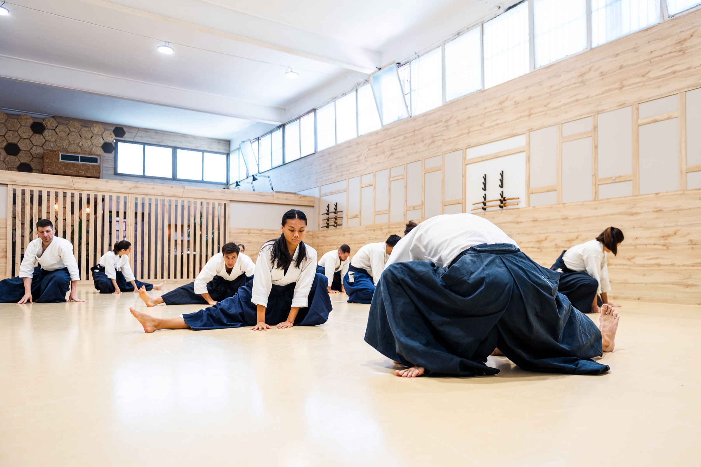 The class warming up together on the mat at the Aikido Musubi dojo.
